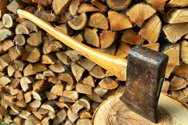 7199730-Axe-set-in-chopping-block-in-front-of-a-woodpile-background-Stock-Photo.jpg